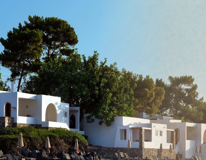 A whitewashed Mediterranean resort nestled against the sea, from the Sojourn Summer 2024 Coolcations feature