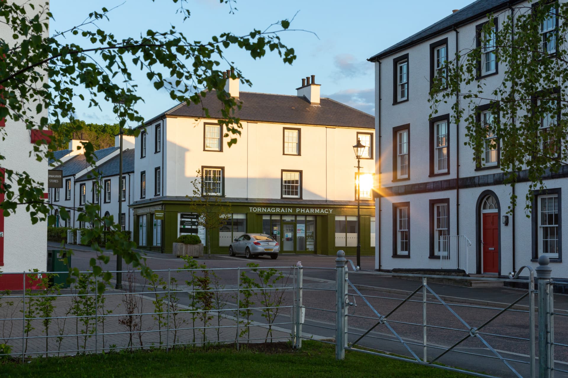 Tornagrain Pharmacy at the centre of the new village, caught in the warm light of early evening