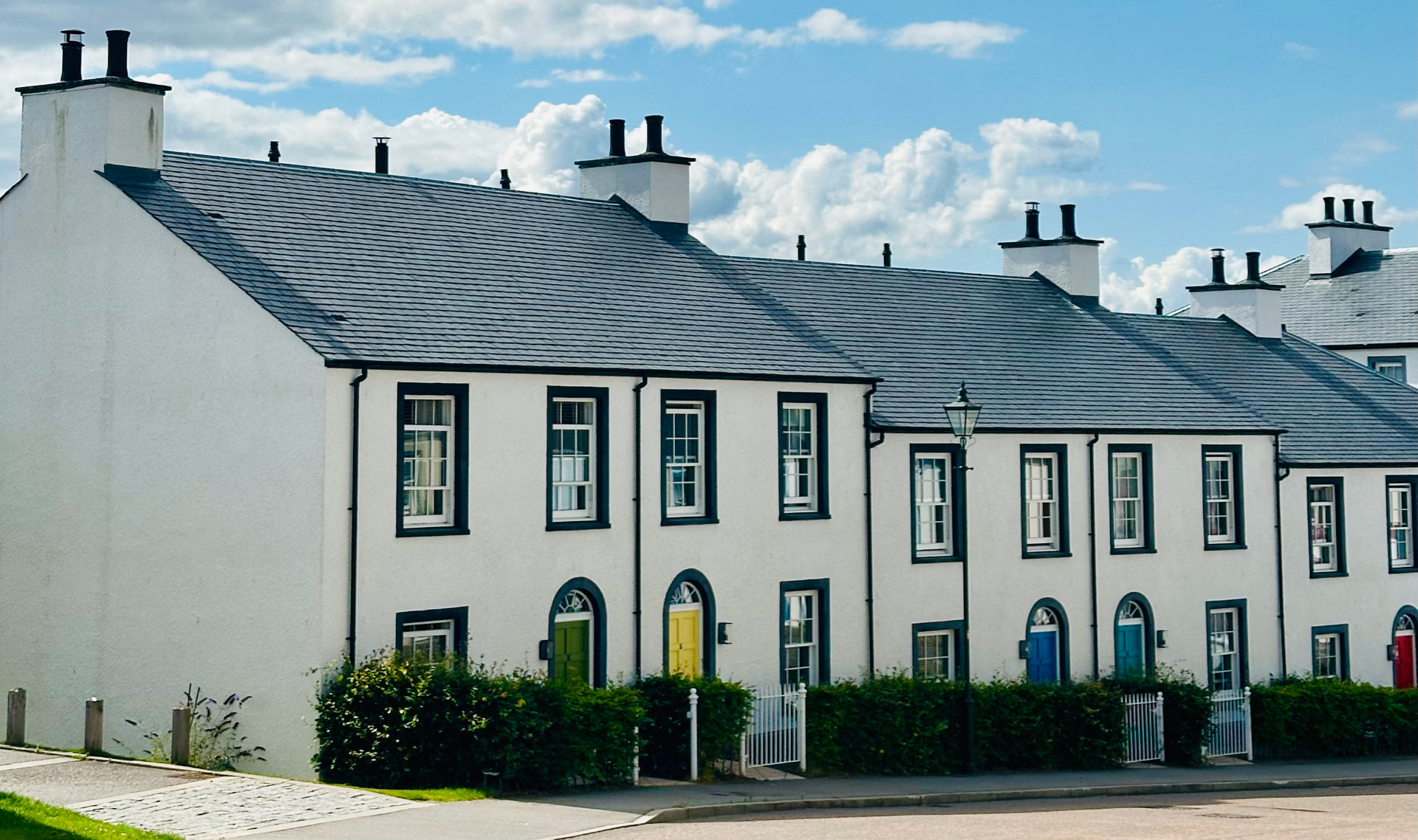 A terrace of Tornagrain houses with brightly coloured front doors